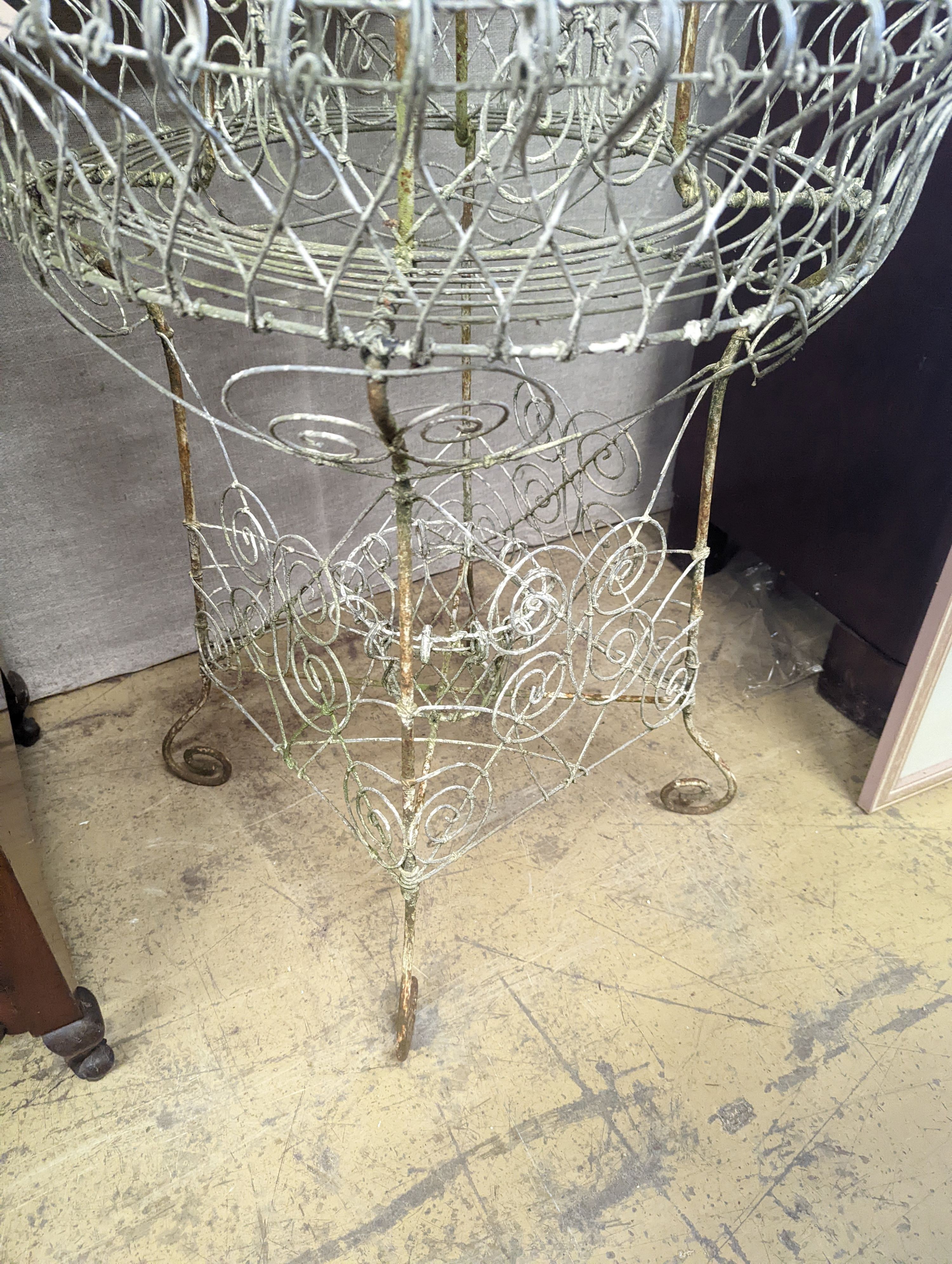 A Victorian painted wirework three tiered plant stand, diameter 65cm, height 112cm